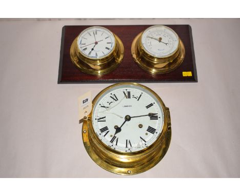 A ship's wall clock in circular brass case, the white roman dial inscribed 'London'; together with a brass cased clock/barome