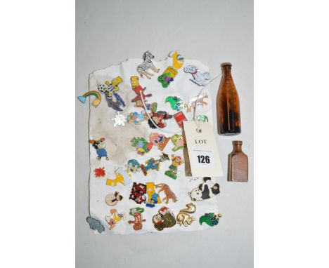 A collection of small enamel badges; and two miniature bottles.