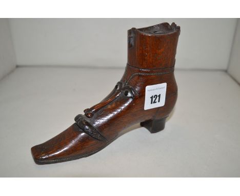 A Victorian treen snuff box in the form of a boot, with carved moustached face decoration.