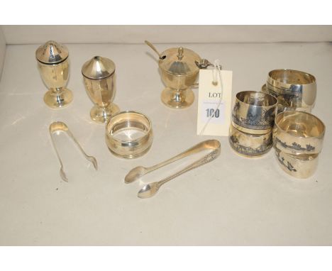 A three-piece silver condiment set, by Joseph Gloster, Birmingham; a set of six Egyptian white metal napkin rings (not matchi