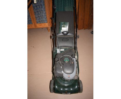 A Hayter Harrier Model 41 petrol driven rotary self propelled lawn mower, with grass collector and instruction book.
