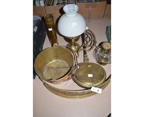 An antique brass bed warming pan; a brass jam pan; a fireside trivet; a brass fire tidy; and a shell case; together with a mo