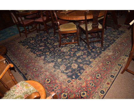An antique Mahal carpet, the blue field with scrolling floral design, 339 x 345cms (areas of wear and hole towards one corner