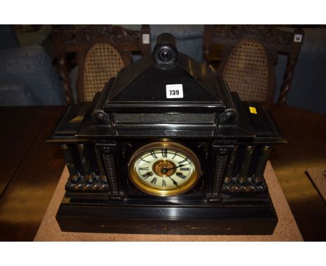 A Victorian mantel clock in ebonised wooden architectural style case, the cream coloured roman dial with gilded highlights.