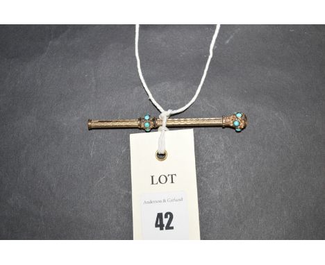 A 19th Century yellow metal and turquoise cabouchon mounted extending propelling pencil, with yellow stone set finial.