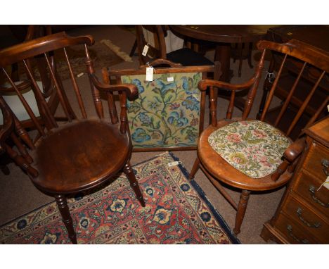 An Ibex carver chair, with curved cresting and arms supported by turned spindles over a solid circular seat, raised on turned