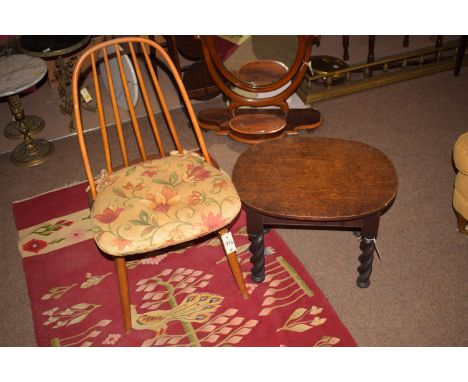 An oak occasional table, raised on barley twist legs; together with an Ercol chair.  (2)