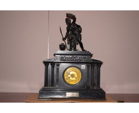 A large late 19th Century black slate architectural style mantel clock with arabic dial, surmounted by a roman warrior with a