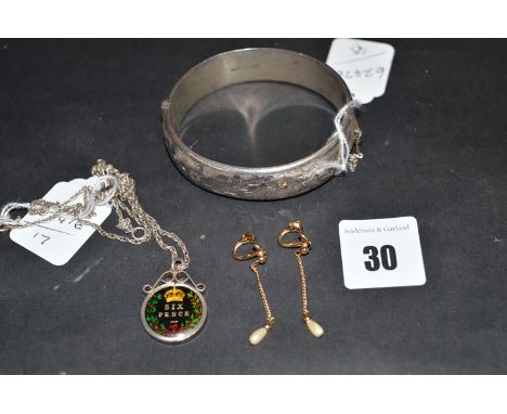 A silver bangle; together with a coloured sixpence pendant on chain; and a pair of yellow metal and cultured pearl drop earri