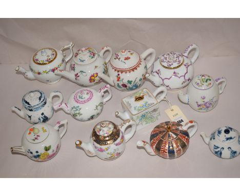 A collection of twelve Franklin Mint reproduction miniature ceramic teapots, retailed by the Victoria & Albert Museum.