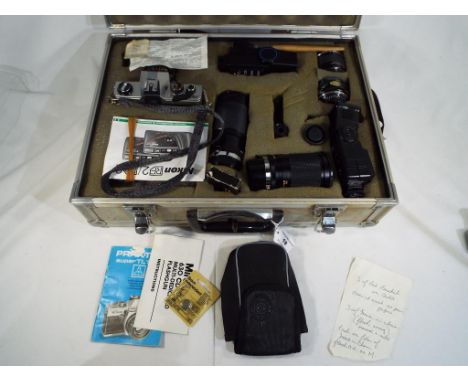 A Praktica Super TL1000 camera in protective hard case with additional lenses, flash gun and other accessories