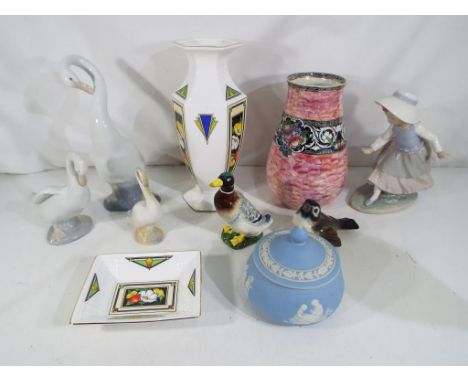 A mixed lot of ceramics to include three Nao figurines, a light blue Jasper Ware lidded pot, a Goebel bird figurine, a New Ha