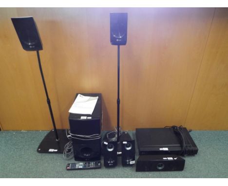 An LG 5.5 channel surround sound system including two speaker stands and instructions