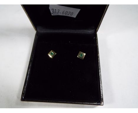 A pair of 9ct yellow gold earrings set with jade stamped 375