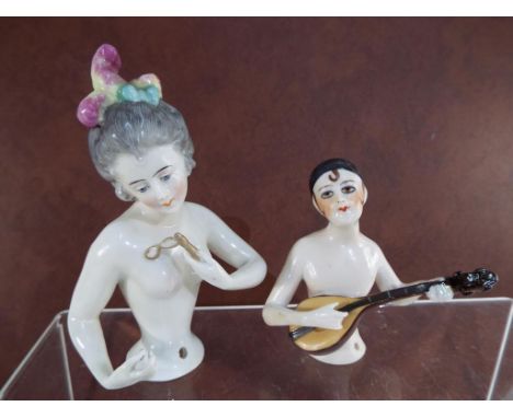 Two 1920's / 1930's ceramic style half doll pin cushions both inscribed markings verso 5769 and 1603, the small 9cm, largest 