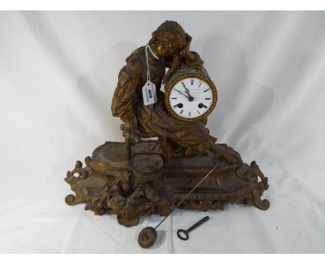 A late 19th century French gilt spelter mantel clock, Roman numerals on a 9 cm diameter white enamel dial flanked to one side