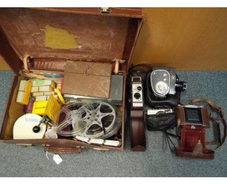 Photography - a vintage suitcase containing a quantity of photographic equipment comprising slides, film, a Polaroid Land Cam