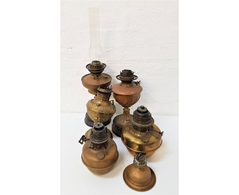 SELECTION OF COPPER AND BRASS EDWARDIAN AND LATER OIL LAMP BASESsome with decorative reservoirs, together with one glass funn