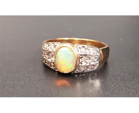 OPAL AND DIAMOND DRESS RINGthe central oval cabochon opal flanked by three rows of diamond to each side, on nine carat gold s