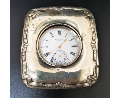 CONTINENTAL SILVER CASED POCKET WATCH IN SILVER MOUNTED STANDthe white enamel dial marked 'Kendal & Dent London', with Roman 