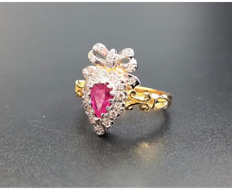 UNUSUAL RUBY AND DIAMOND CLUSTER RINGthe pear cut ruby in diamond surround and surmounted by a diamond set bow, on eighteen c