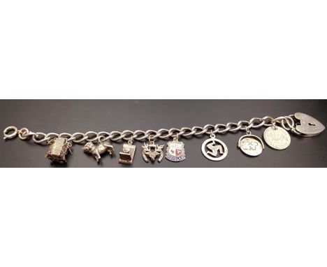 SILVER CHARM BRACELETthe curb link bracelet with heart padlock clasp and a variety of charms including an Isle of Mann three 