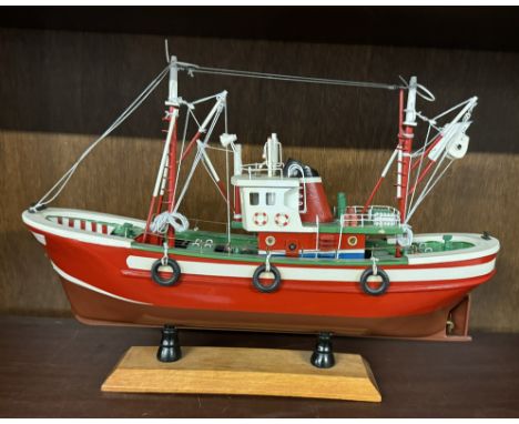 A model ship on a rectangular shelf