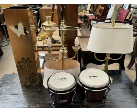 A pair of brass table lamps together with a chinoiserie decorated umbrella stand and a pair of bongo drums