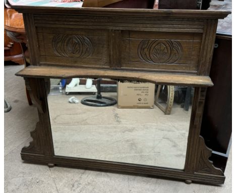 An Edwardian oak overmantle mirror with a shelf and rectangular mirror plate, 86.5cm long x 89cm high x 8cm deep