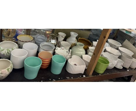 A large collection of pottery plant pots and jardinieres