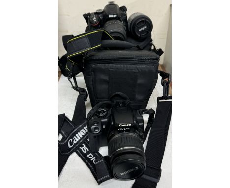 A Canon EOS 400D digital camera together with a Nikon D5100 digital camera and lenses