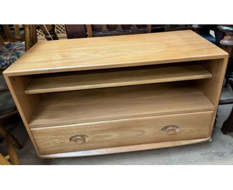 An Ercol light oak television cabinet