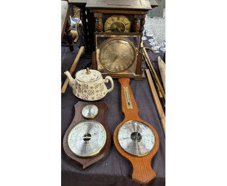 An oak framed barometer together with two other barometers, clocks and a teapot