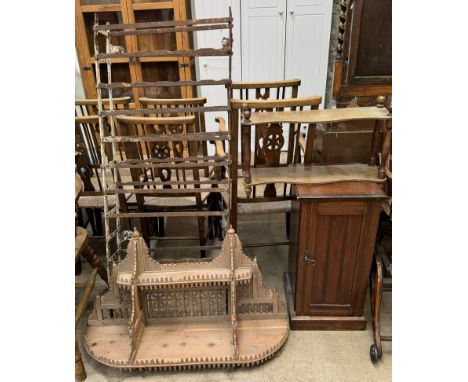 A steel wall mounted wine rack together with a fret work and spindle carved shelf unit, pot cupboard and a shelf unit