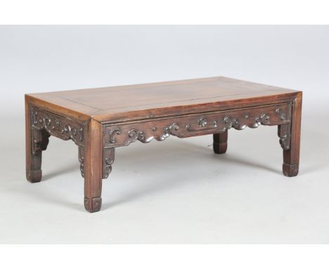 A Chinese hardwood rectangular low table, 20th century, the rectangular panelled top above a scroll frieze on block legs, len