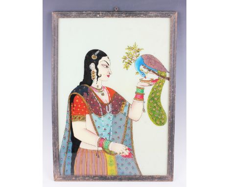 An Indian reverse painting on glass, late 19th/early 20th century, depicting a half-length portrait of a princess feeding a p