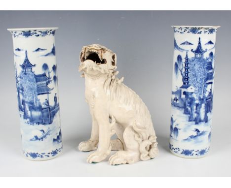 A pair of Chinese blue and white porcelain cylinder vases, mark of Kangxi but late 19th century, each painted with flowers an