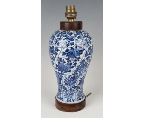 A Chinese blue and white porcelain vase, Kangxi period, the baluster body with spiral moulded and lappet borders painted with