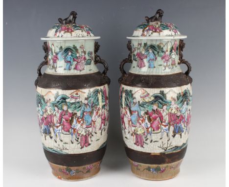 A pair of Chinese famille rose crackle glazed porcelain vases and covers, late 19th century, each shouldered body and tapered