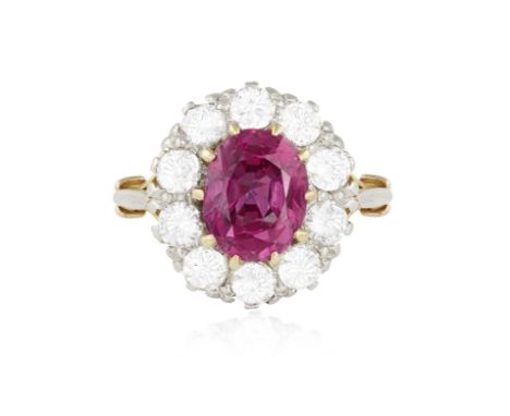 A RUBY AND DIAMOND CLUSTER RINGThe central oval-shaped ruby weighing approximately 4.80cts within a multiple claw setting and