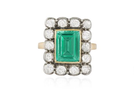 A FINE EMERALD AND DIAMOND DRESS RING, CIRCA 1900The rectangular emerald weighing approximately 3.50cts within collet-setting