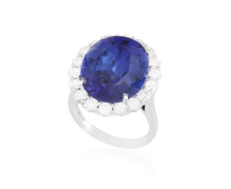 AN IMPORTANT TANZANITE AND DIAMOND CLUSTER RINGThe oval-shaped tanzanite weighing approximately 11.35cts within a four-claw s