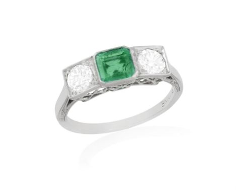 AN EARLY 20TH CENTURY EMERALD AND DIAMOND RINGThe square-cut emerald set between two old European-cut diamonds, within milleg