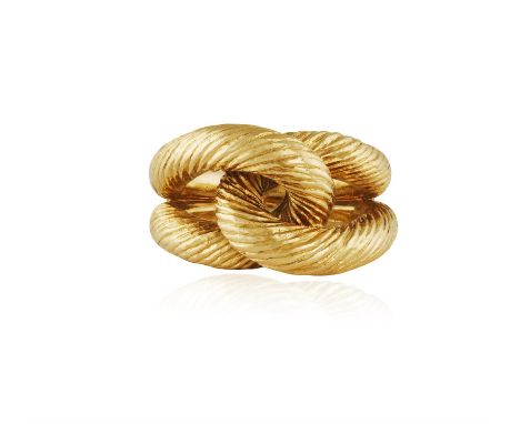 A GOLD DRESS RING, BY CARTIER, CIRCA 1960Of fluted knot design, in 18K gold, signed Cartier Paris, numbered, with maker's mar