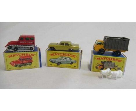 Matchbox 35b Snow Track, box M, model M, 36 Opel Diplomat in gold, one box flap damaged, boxed G, model E-M, 37c Dodge Cattle