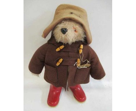 Paddington bear, with brown felt coat, hat, label and red Dunlop boots (Est. plus 24% premium inc. VAT)Condition Report: Gene