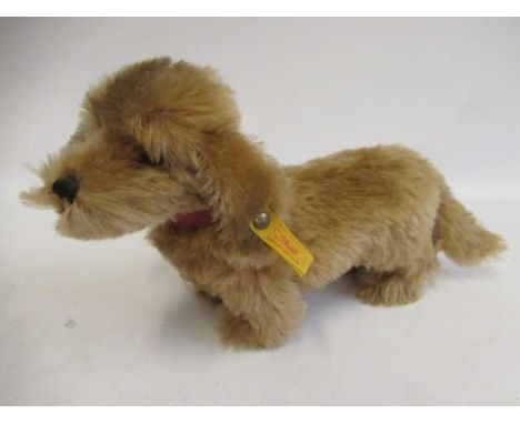 A Steiff Waldi dog, with brass button, label, card tag and leather collar, 30cm long (Est. plus 24% premium inc. VAT)Conditio