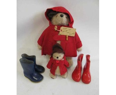 Paddington bear, with brown felt hat, red coat, label and a pair of blue Dunlop boots, together with a pair of red boots and 