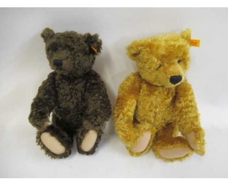 Two Steiff bears, comprising a 13 1/3" brown growling bear and a 13 1/2" bear with orange plush, both with felt pads, label, 