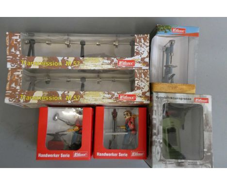Wilesco workshop equipment comprising two line shafts, steel press, drill press and two workshop figures, all items boxed, E-